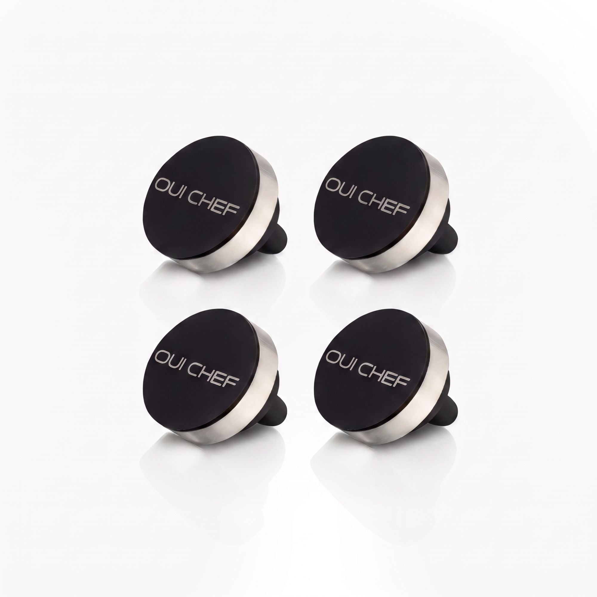 Oui Chef HoldFast Magnetic Chef's Pin 4 Pack with four black magnetic pins for chef jackets and aprons on a white background