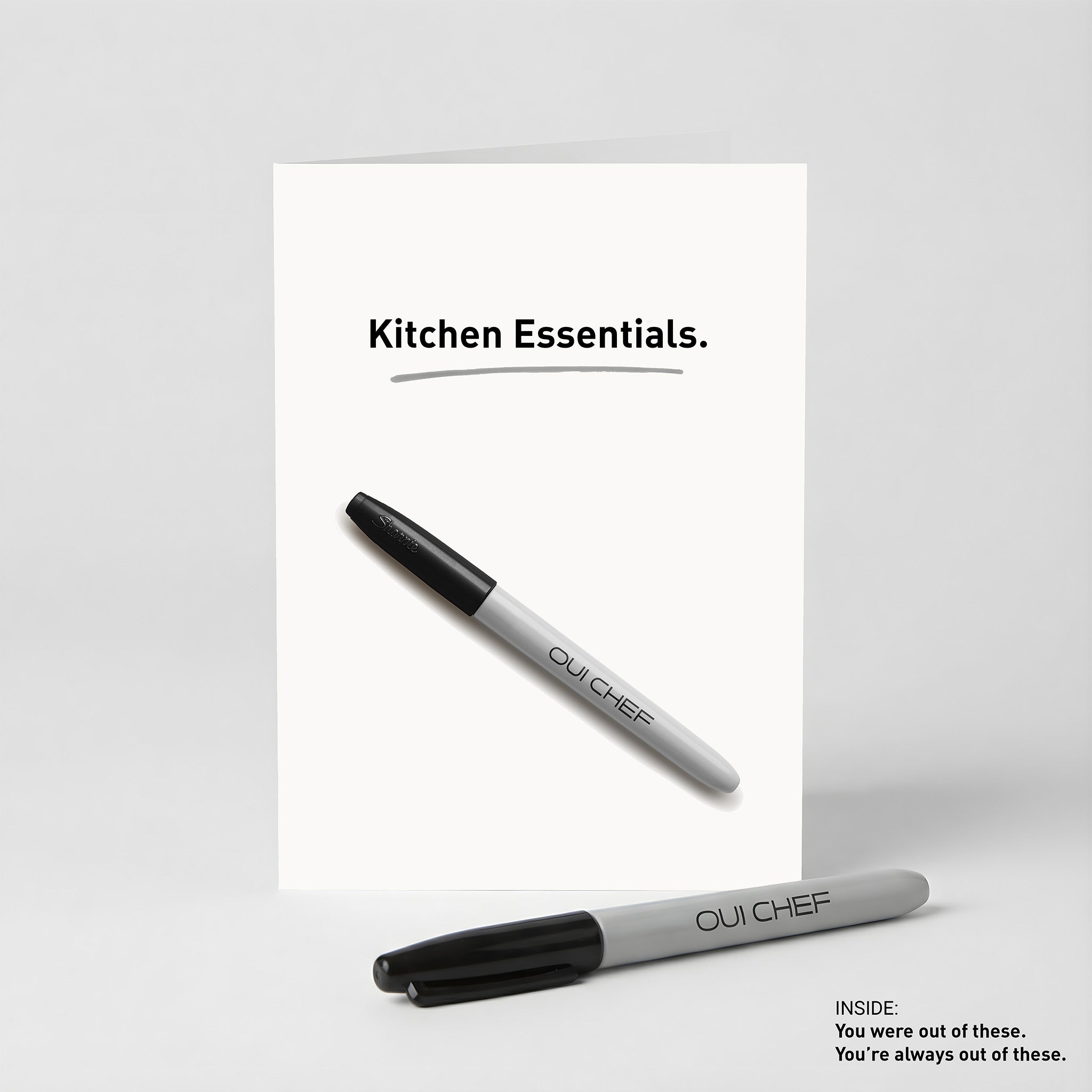 Oui Chef Kitchen Essentials Greeting card standing against a white background with a sharpie placed beside it.