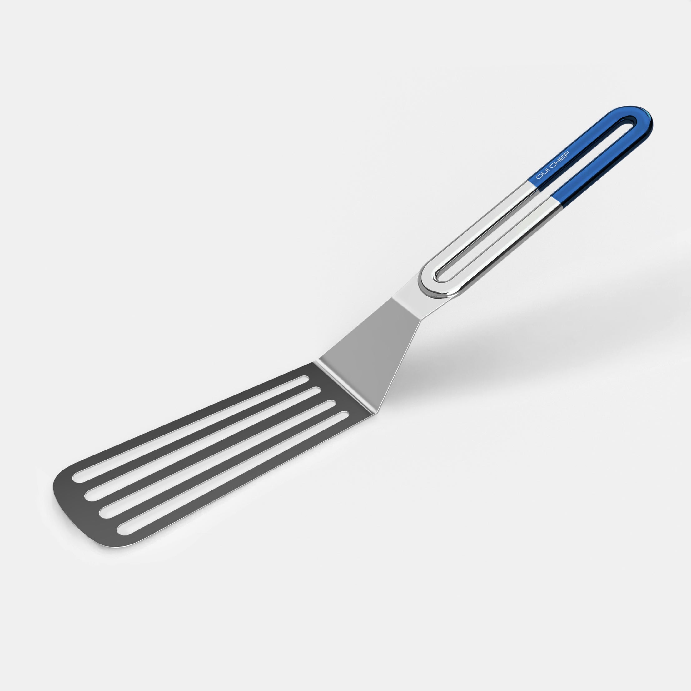 A stainless steel slotted spatula with a blue coloured handle against a white background.